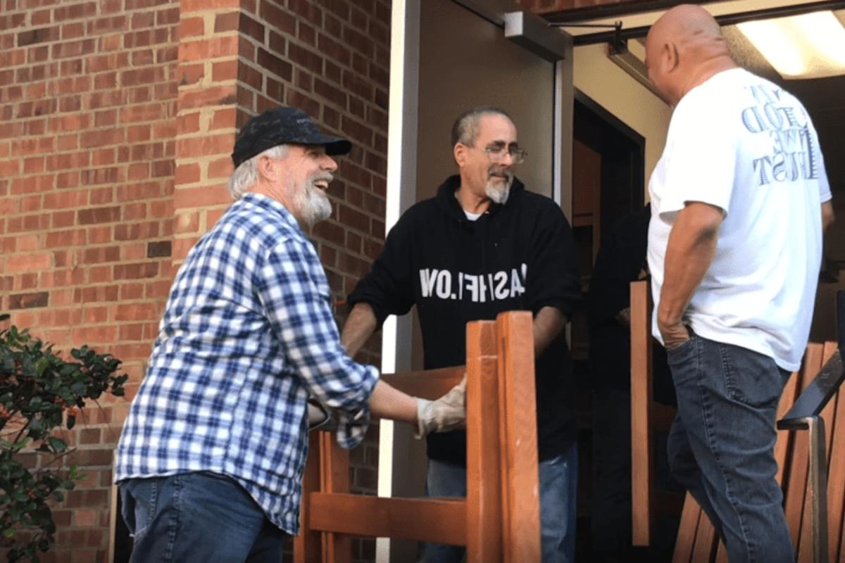 men take furniture out of a dorm building