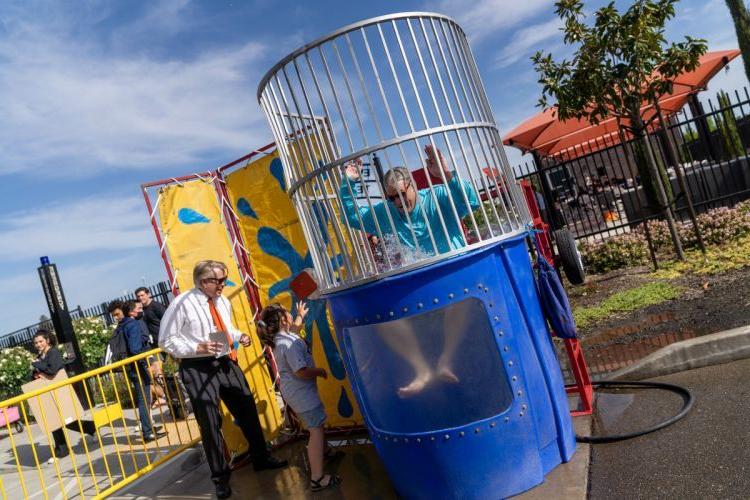 Gale with President Christopher Callahan at the "dunk the dean" tank during Admitted Student Day in 2022. 